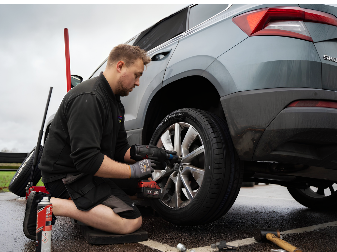 Technician fitting a replacement tyre